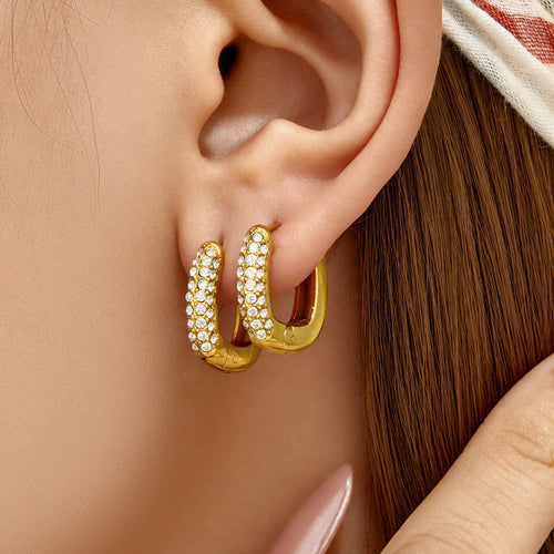 Selene gold pavé huggie hoops worn in the ear