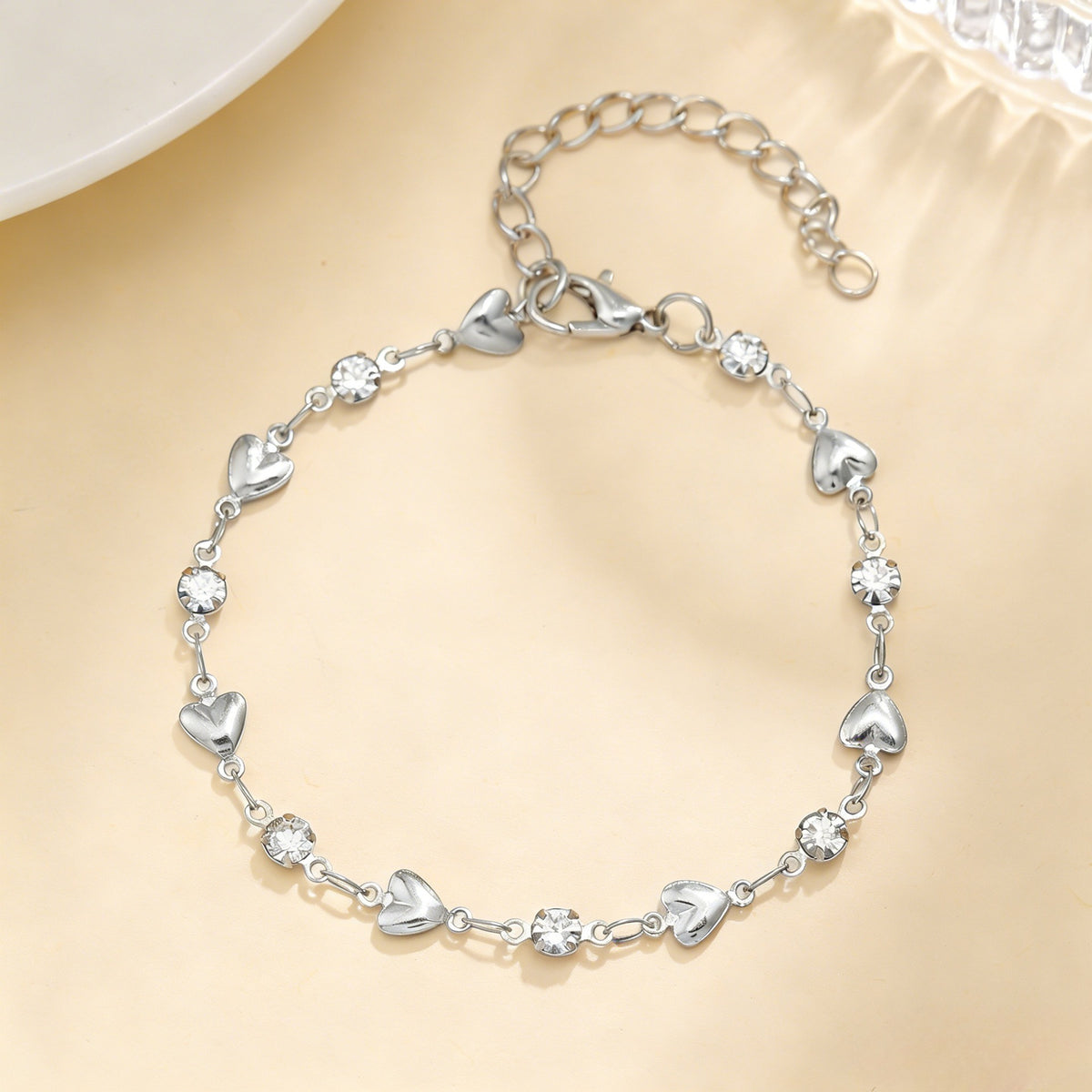 Venus Heart Bracelet in silver — polished hearts and clear stones with extender chain