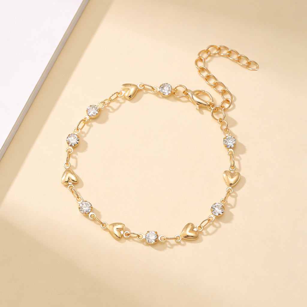 Venus Heart Bracelet in gold — polished hearts and clear stones with extender chain